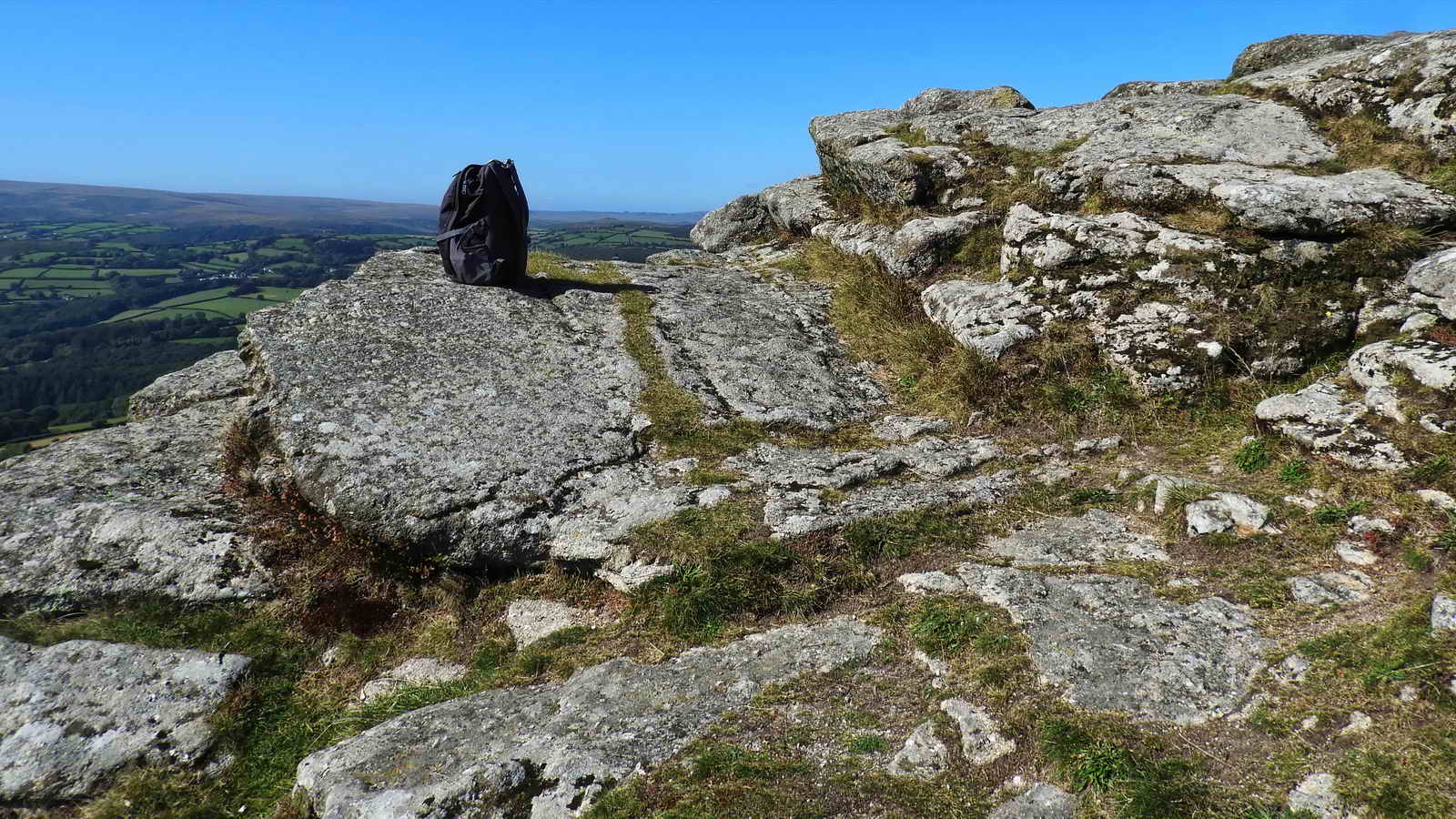 The rucksack is at the top of the stone