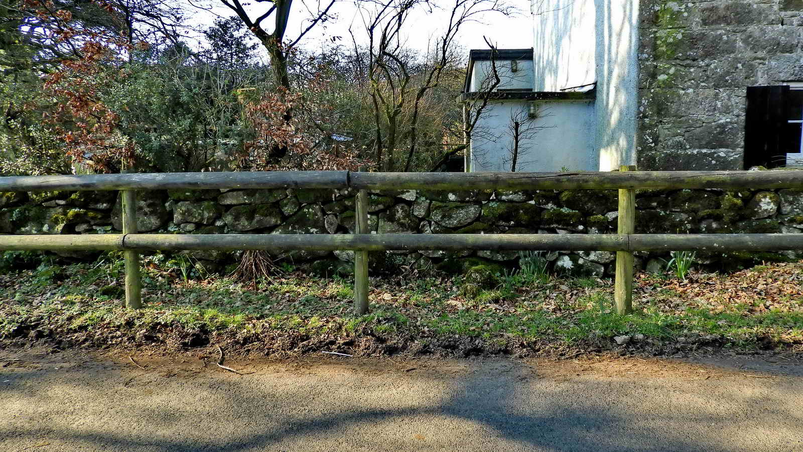 The cross can be seen a few inches to the right of the middle fence post