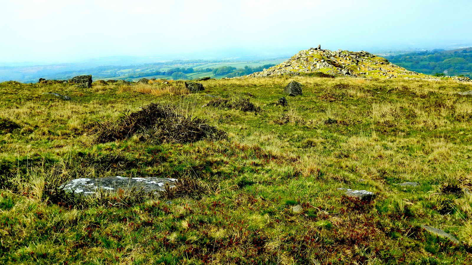 Showing the displaced capstone of the cist, with Ingra Tor behind