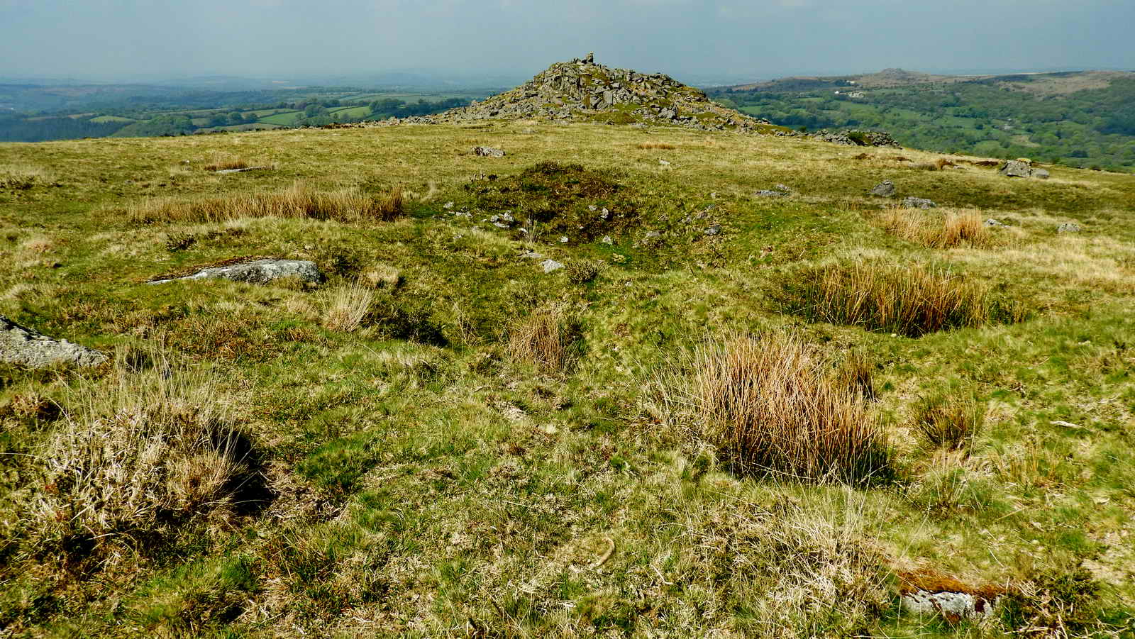 Scattered pits near the cairn are described as “stone pits” by Butler in his description of the cairn