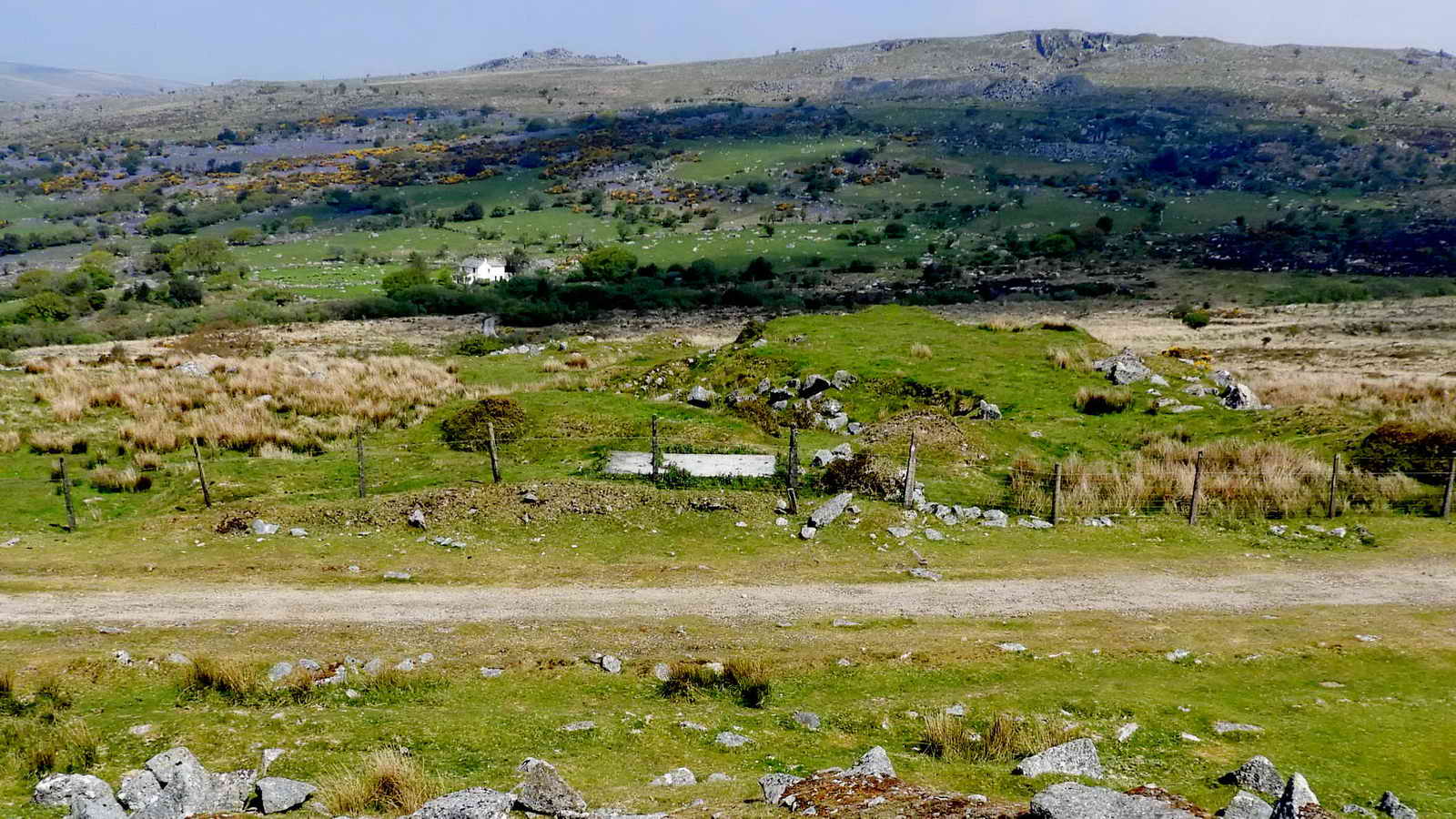 Looking down to the railway and concrete base of a basic shelter - the only remains of Ingra Tor Halt