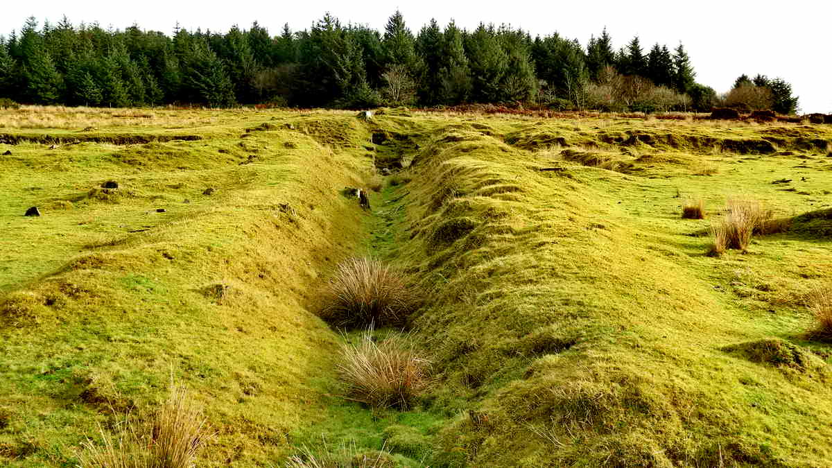 Upper dressing floor. Looking up the tailrace to the large wheelpit, with the raised embankment that brought the water to the waterwheel (via a launder) behind