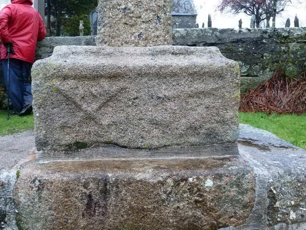 The crossed keys of St Peter with an anchor to their right, on the south face of the medieval crown stone, supporting the reconstructed village cross