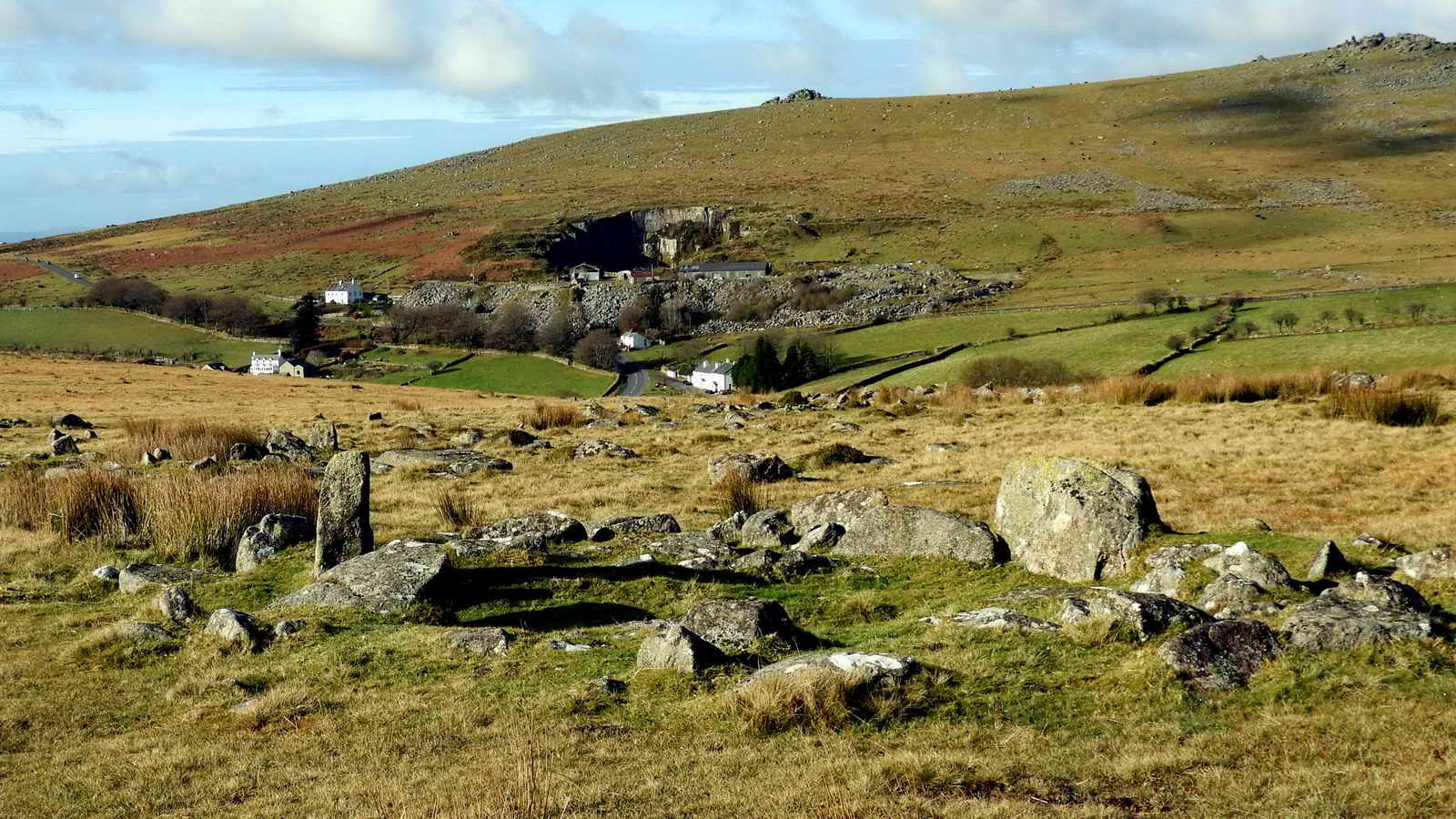 Merrivale Quarry in the distance, with a hut circle in the foreground