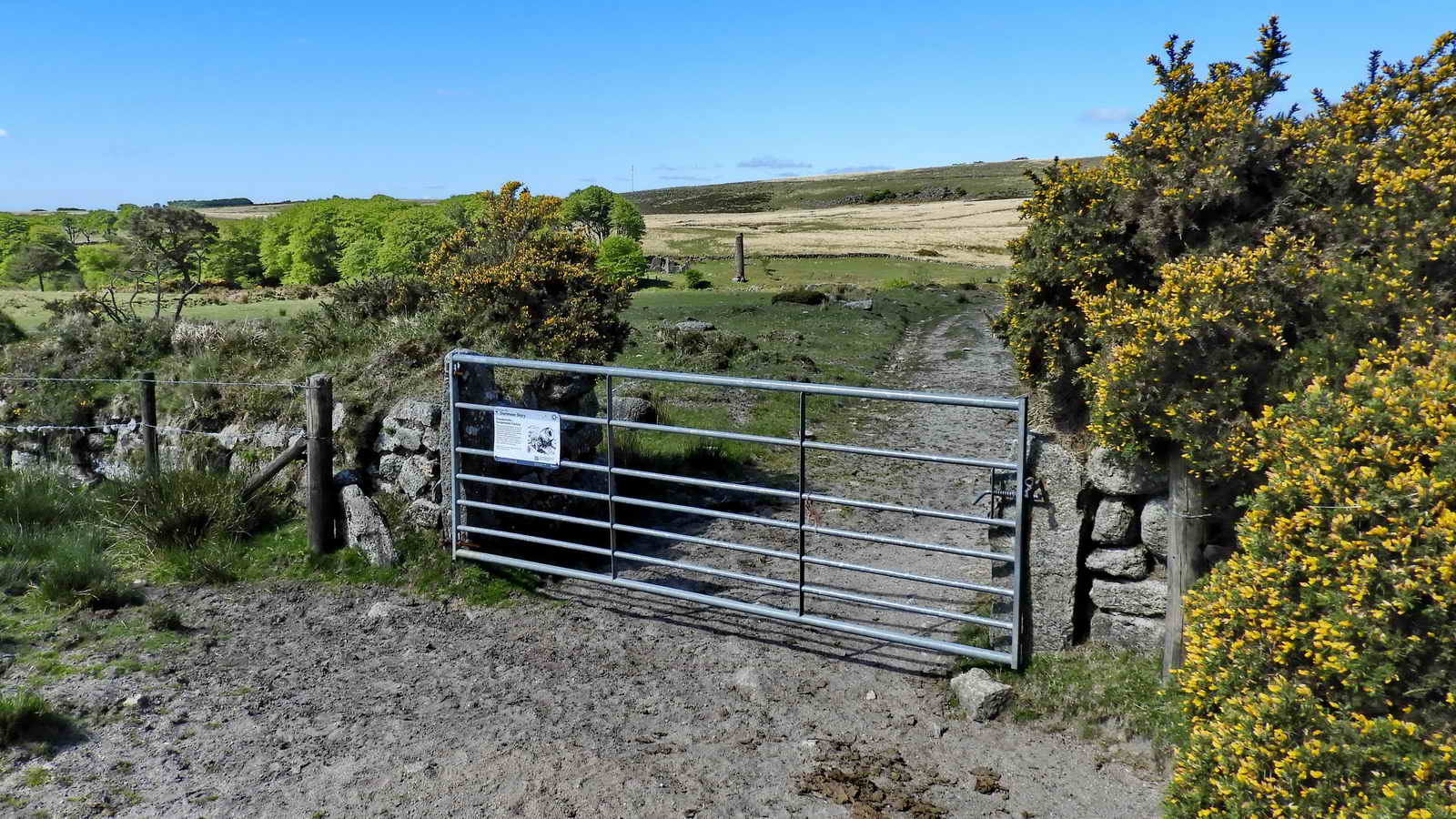 The gate at the north end of the Powdermills site, with the North Chimney in view. The buildings run left, under the tree